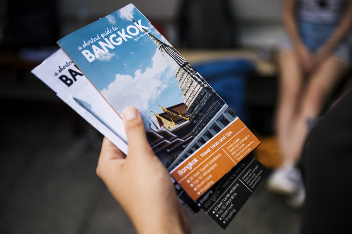 Closeup Of Hand Holding Bangkok Travel Guide Brochure